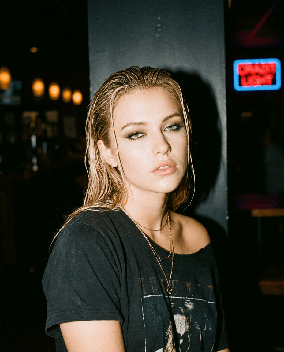 A hard-flash nightlife portrait with wet-look hair and a vintage band tee, generated with Moire